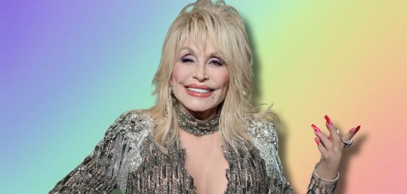 Dolly Parton in a silver outfit smiling, holding her hand in out. She is imposed against a rainbow background.