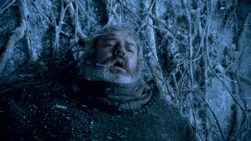 Game of Thrones still: Kristian Nairn as hodor in snowy winter tangled int he roots of a tree
