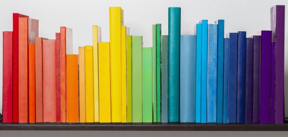Multicoloured books on bookshelf.