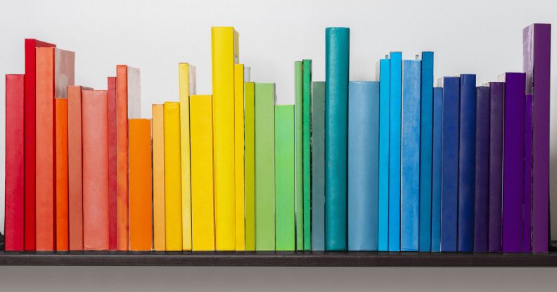 Multicoloured books on bookshelf.