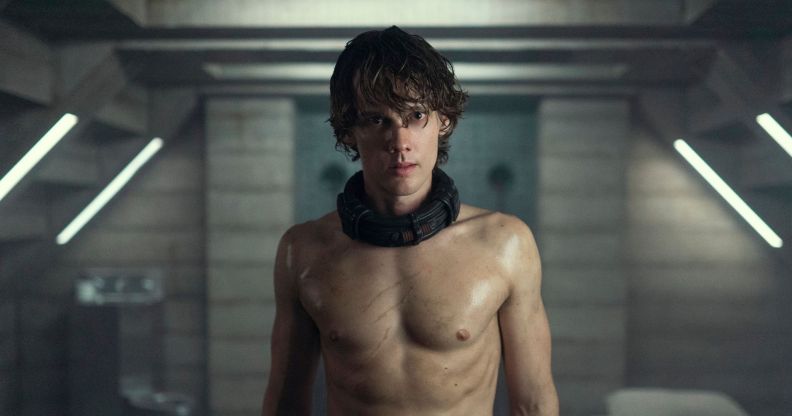 A shirtless Hunter Doohan in Wednesday season two in a dingy dungeon.