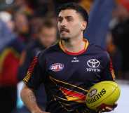 Izak Rankine of the Crows warms up during the 2025 AFL Round 23 match between the Adelaide Crows and the Collingwood Magpies at Adelaide Oval on August 16, 2025 in Adelaide, Australia.