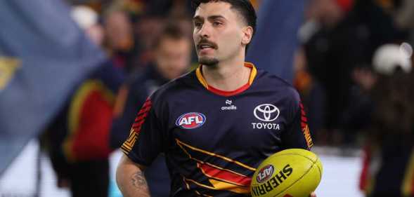 Izak Rankine of the Crows warms up during the 2025 AFL Round 23 match between the Adelaide Crows and the Collingwood Magpies at Adelaide Oval on August 16, 2025 in Adelaide, Australia.