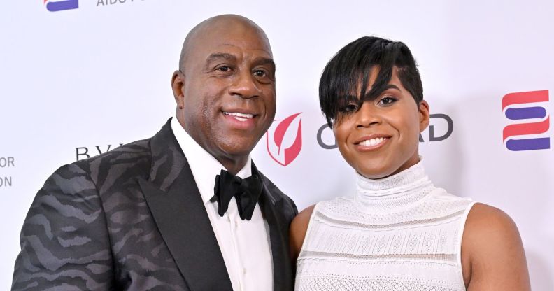 Magic Johnson and his gay son, EJ Johnson smile on a red carpet together.