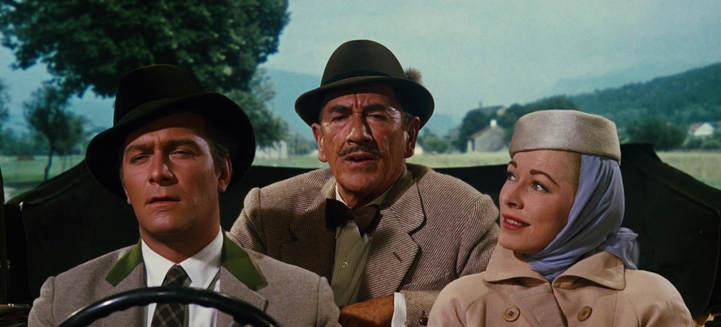 The Sound of Music still: the captain driving Max sat in the back middle of the car and the Baroness in the passenger seat.