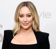 Hilary Duff on a red carpet in a black pansuit