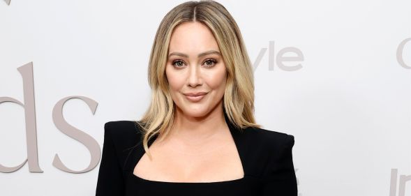 Hilary Duff on a red carpet in a black pansuit