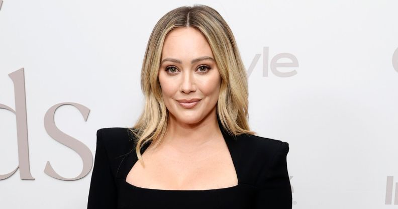 Hilary Duff on a red carpet in a black pansuit