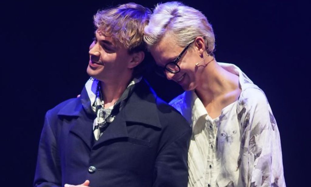 Linus Karp and Joseph Martin embracing.