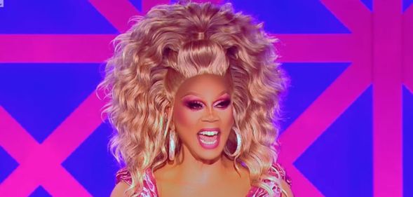 RuPaul laughs on the judging panel of Drag Race UK season two.
