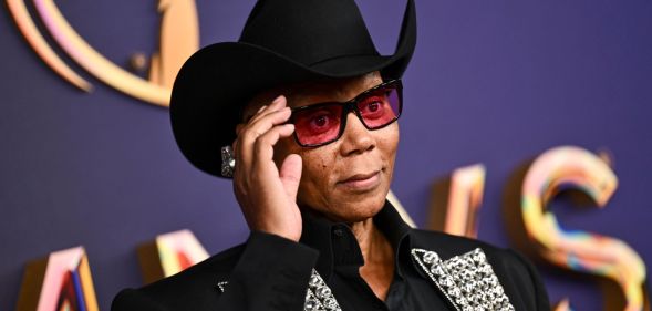 RuPaul stands on the red carpet