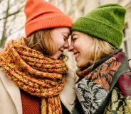 Two women lovingly embracing.