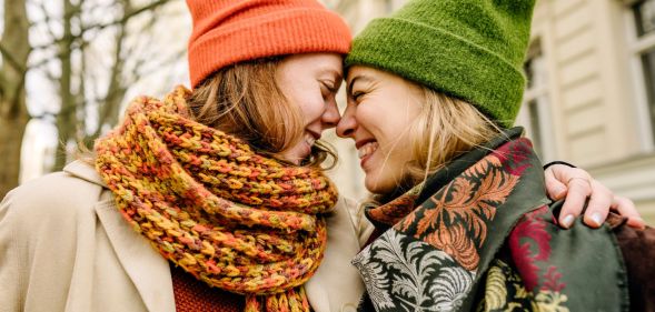 Two women lovingly embracing.