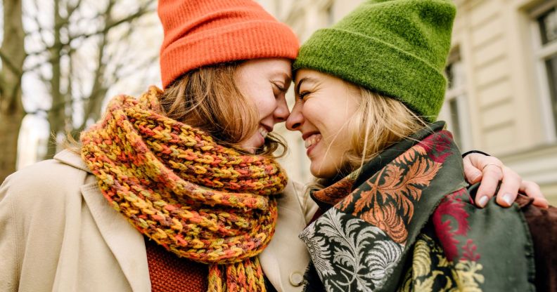 Two women lovingly embracing.