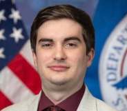 Eric Lendrum pictured in front of the DHS logo