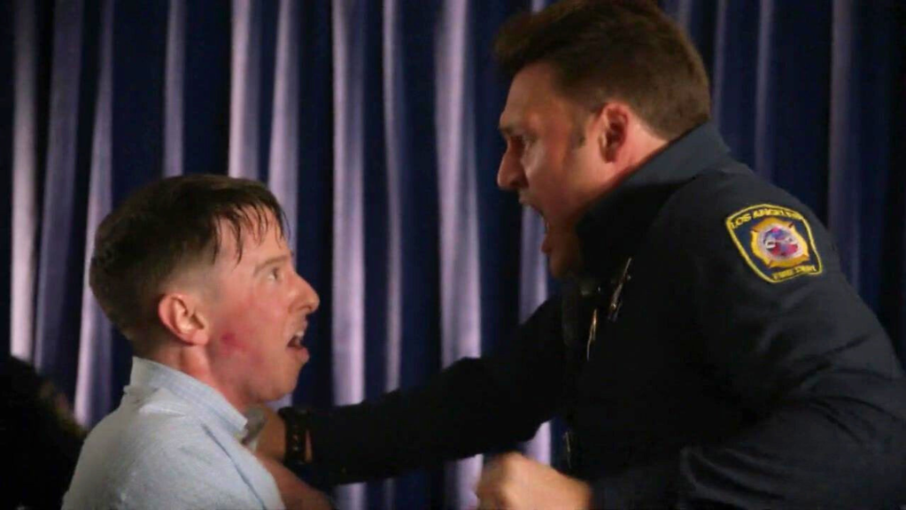 A man grabbing Eddie's crotch.