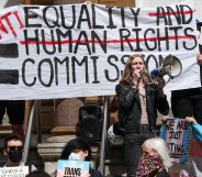 Protestors holding a sign during a trans rights rally.