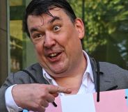 Graham Linehan, pictured pointing at a placard he is wearing.