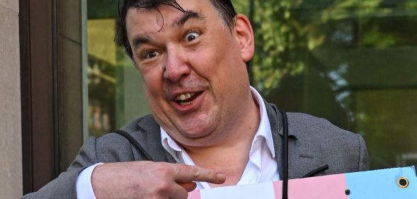 Graham Linehan, pictured pointing at a placard he is wearing.