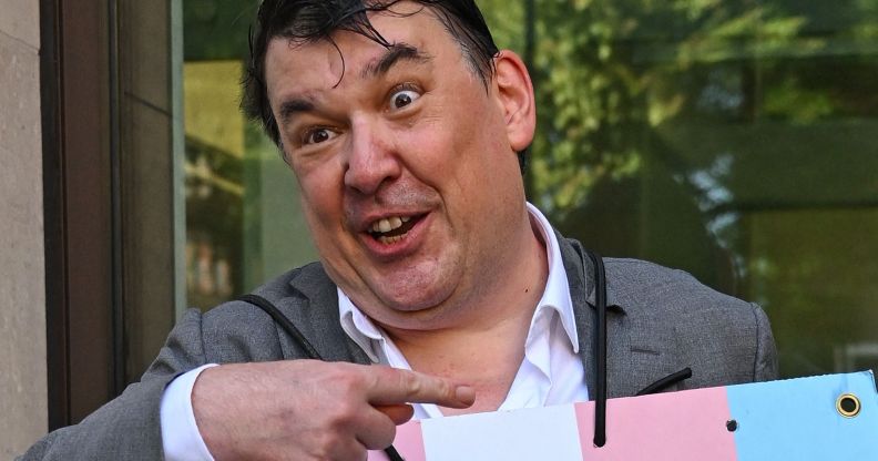 Graham Linehan, pictured pointing at a placard he is wearing.