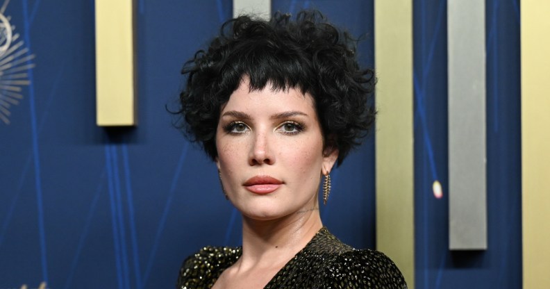 Halsey at the 77th Primetime Emmy Awards. She's wearing a snake skin patterned gold and black dress.