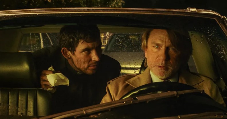 Wake Up Dead Man: A Knives Out Mystery still: Daniel Craig in the driver's seat with Josh O'Connor leaning from the back seat to speak to him.