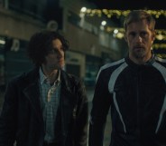 Pillion still: Harry Melling and Alexander Skarsgård walking together at night.