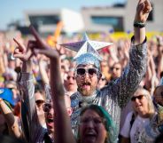 Eurovision fans enjoy the party atmosphere as they gather in Liverpool to watch the Eurovision Song Contest final on a giant screen in the Eurovision Village on May 13, 2023