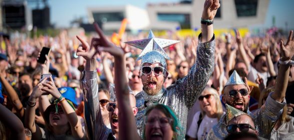 Eurovision fans enjoy the party atmosphere as they gather in Liverpool to watch the Eurovision Song Contest final on a giant screen in the Eurovision Village on May 13, 2023