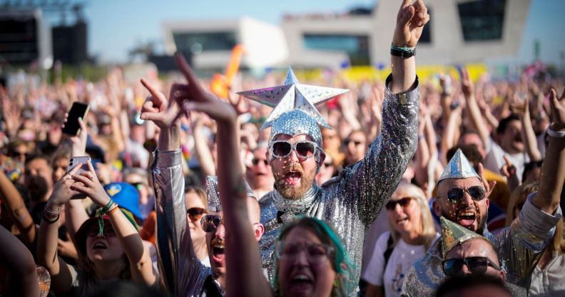Eurovision fans enjoy the party atmosphere as they gather in Liverpool to watch the Eurovision Song Contest final on a giant screen in the Eurovision Village on May 13, 2023