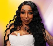 Tiffany Pollard in a white top smiles. She is super imposed against a blurry yellow, purple, white background.