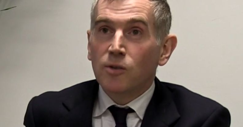 Tim Allan, pictured speaking in a suit and tie.