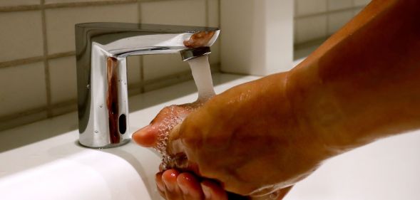 An unpictured person washing their hands.