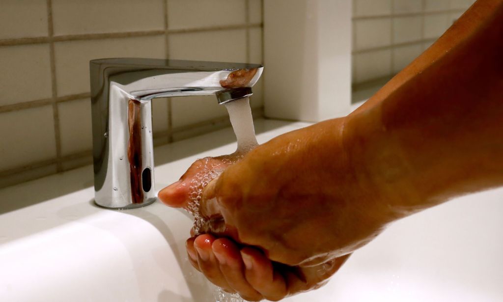 An unpictured person washing their hands.