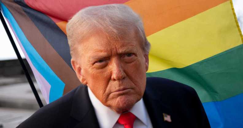 Donald Trump stands in front of Progress Pride flag.
