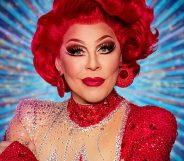La Voix with red hair and red sequined earings and dress