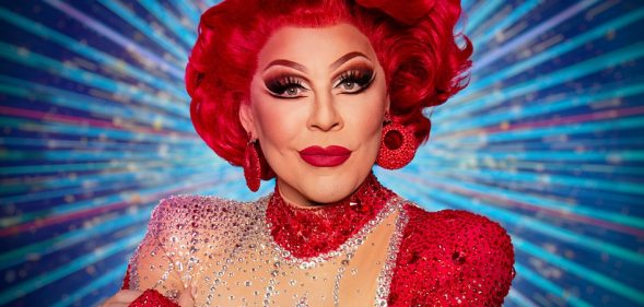 La Voix with red hair and red sequined earings and dress