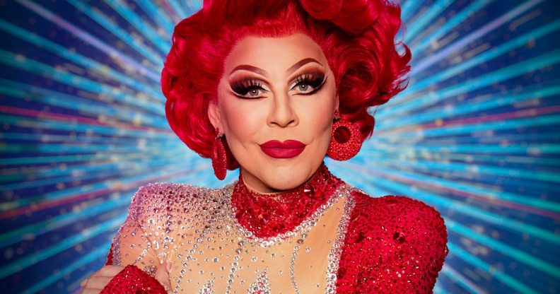 La Voix with red hair and red sequined earings and dress