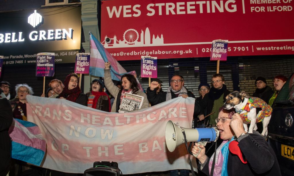 Protestors outside of Wes Streeting's office, holding pro-trans signs.