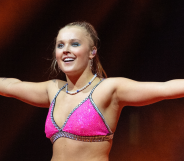 JoJo Siwa on stage in London in a pink sparkly top.