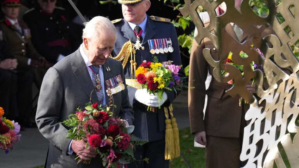 King Charles III lays flowers during the dedication ceremony for a new memorial to the Armed Forces LGBTQ+ community at Founders Room National Memorial Arboretum.