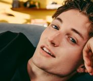 Henry Moodie poses with his head resting on his hand.