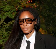 Janelle Monáe in a black and white suit with her hair down.