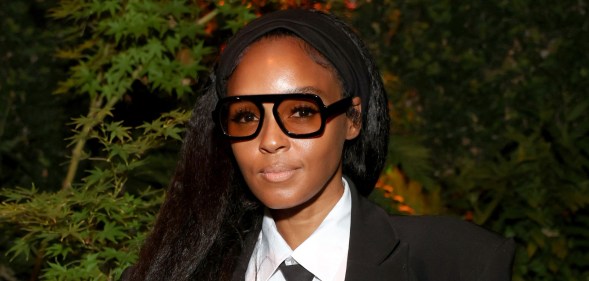 Janelle Monáe in a black and white suit with her hair down.