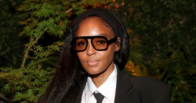 Janelle Monáe in a black and white suit with her hair down.