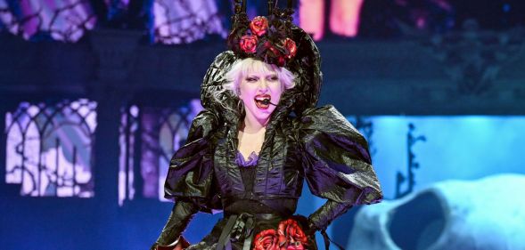 Lady Gaga smiles as she performs at the Mayhem Ball in London.