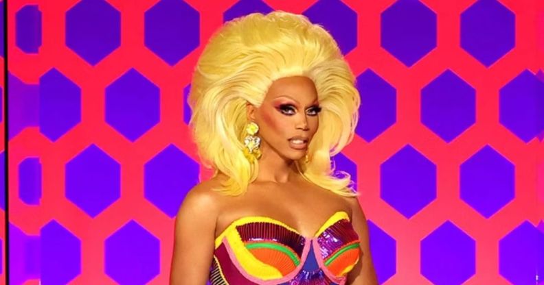 RuPaul smiling on the Drag Race judging panel.