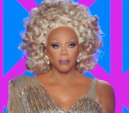 RuPaul in a gold shiny dress on the judging panel of Drag Race UK season 7.