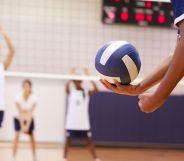 Someone holding a volleyball.