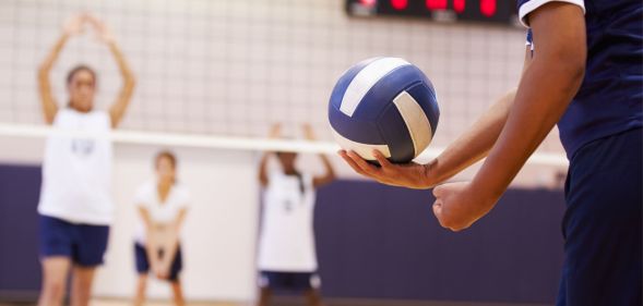 Someone holding a volleyball.